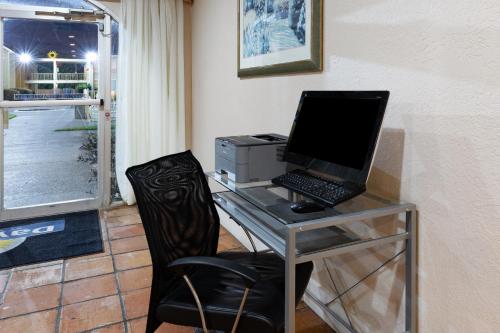 a desk with a laptop computer and a printer at Days Inn by Wyndham Del Rio in Del Rio