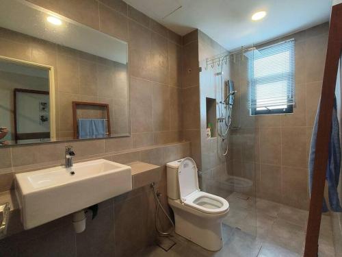 a bathroom with a sink and a toilet and a shower at LovelySea Holiday TimurBay 1R1B condo 4pax恋恋海之屋度假村 in Kuantan