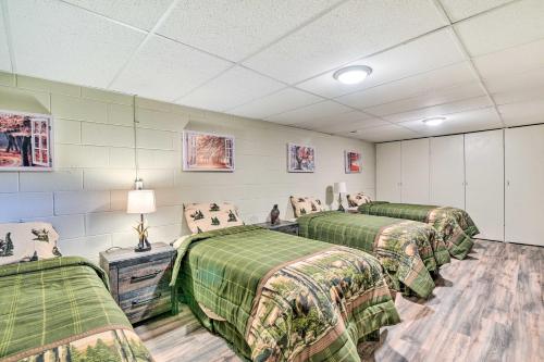 Habitación con 3 camas y mantas verdes en Cozy Cass City Retreat with Spacious Deck! en Cass City