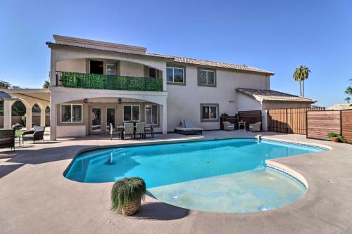 a house with a swimming pool in front of a house at Lavish Family Escape with Game Room in Avondale! in Avondale