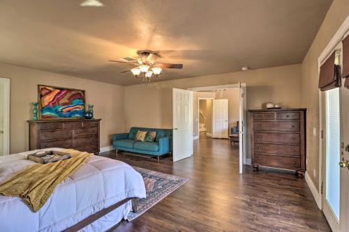 a bedroom with a bed and a blue couch at Lavish Family Escape with Game Room in Avondale! in Avondale