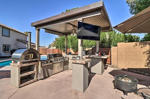 a outdoor kitchen with an outdoor grill and a grill at Lavish Family Escape with Game Room in Avondale! in Avondale