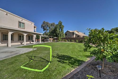 a green volleyball net in the yard of a house at Lavish Family Escape with Game Room in Avondale! in Avondale