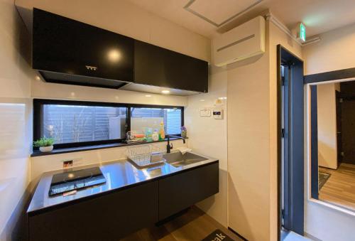 a kitchen with a sink and a counter top at Miyanonoki guest house with Free Parking in Tokyo