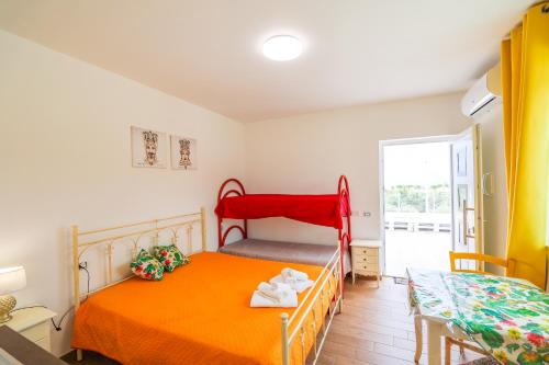 a bedroom with two beds and a window at Cà del Re Holiday in Partinico