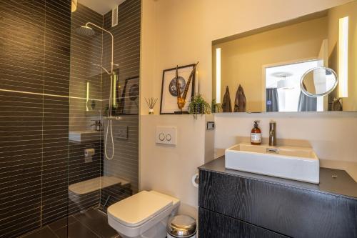 a bathroom with a sink and a toilet and a shower at Modern luxury beach Penthouse in La Herradura