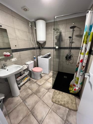 a bathroom with a shower and a toilet and a sink at San Agustin apartments , close to the BEACH, with pool! in San Bartolomé