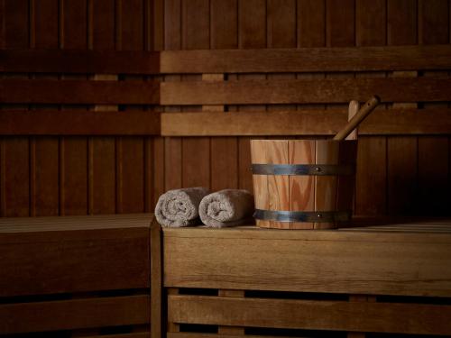 two towels sitting on a table in a sauna at Careys Manor Hotel & SenSpa in Brockenhurst