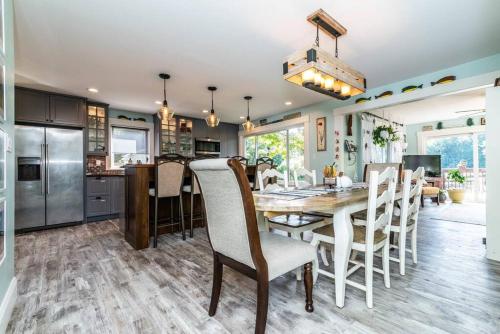 a kitchen and dining room with a table and chairs at Chelsea Lake House, Game Room, & Pontoon-rental in Chelsea