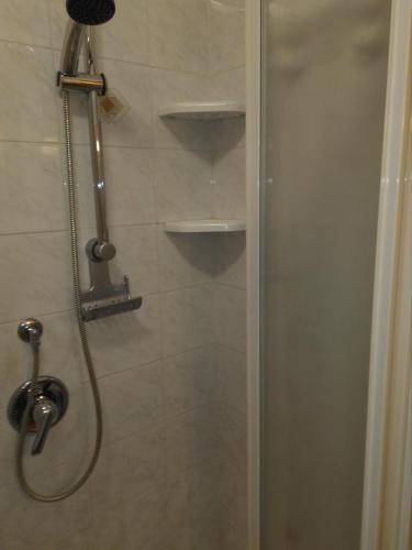 a shower with a glass door in a bathroom at LA CASA DI PUFFY in Selvino