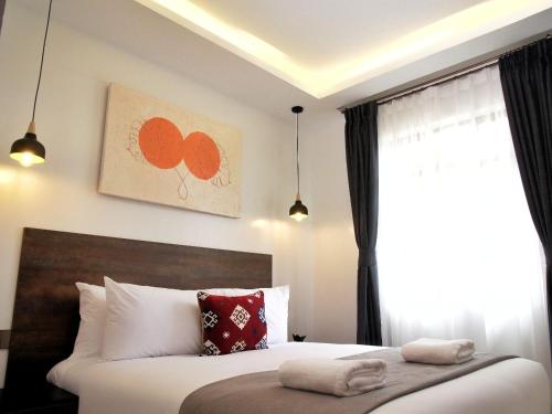 a bedroom with a large bed and a window at Zendo Suite in Nairobi