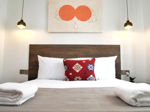 a bedroom with a bed with red pillows on it at Zendo Suite in Nairobi
