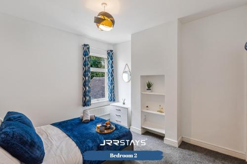 a bedroom with a bed with a blue blanket at Stoke On Trent - 2 Bedroom Sleeps 5, Wi-Fi, Garden - JRR Stays in Etruria