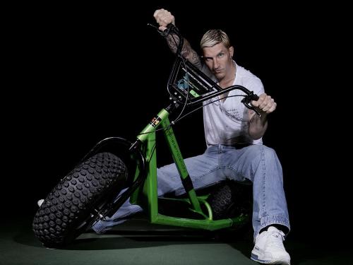 a man is sitting on a green dirt bike at k1 sporthotel - Bike & Ski inklusive Hotel in Kurort Oberwiesenthal