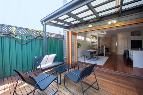 a patio with chairs and a piano on a deck at Renovated 3 Bedroom Family Home in Richmond with Parking in Melbourne