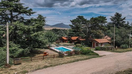 a house with a swimming pool in the yard at Cabañas del Golf in Sierra de la Ventana