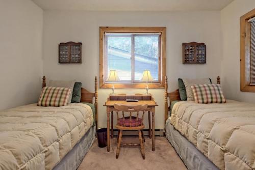 a room with two beds and a table with a window at Hannahs Perch on Lake Burton with Private Top Patio and Bottom Dock in Clayton