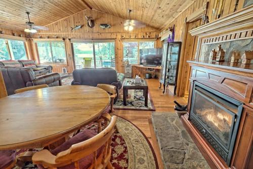 a living room with a table and a fireplace at Hannahs Perch on Lake Burton with Private Top Patio and Bottom Dock in Clayton