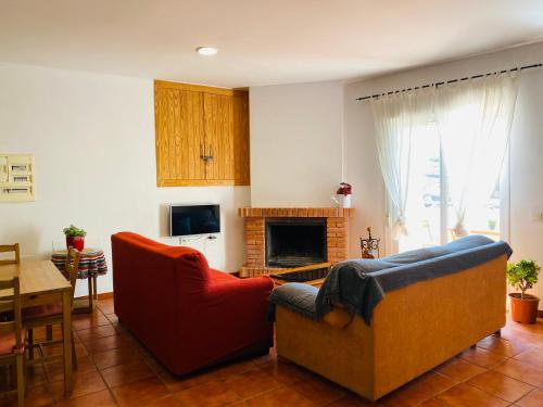 sala de estar con 2 sillas y chimenea en Casa Alma en Almería