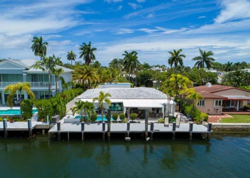 a house on the water with a dock at Casa Flamingo Intracoastal Front with Heated Pool a and 75 ft Dock in Fort Lauderdale