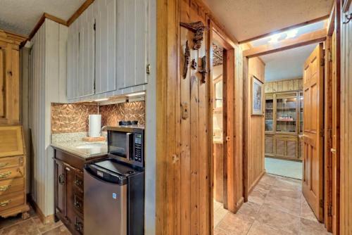 a kitchen with wooden cabinets and a stove top oven at Bills Bungalow on Lake Burton with Top Dock and Patio in Clayton