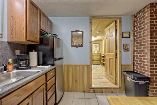a kitchen with a sink and a door to a room at Bills Bungalow on Lake Burton with Top Dock and Patio in Clayton