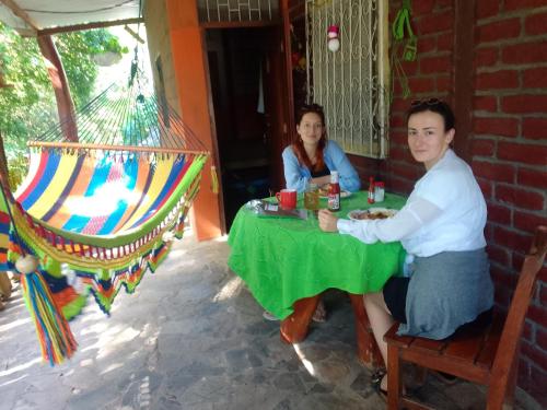 a man and a woman sitting at a table at Beach cabin ometepe in Altagracia