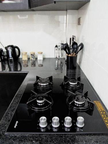 a kitchen counter with four burners on a stove top at Zendo Suite in Nairobi