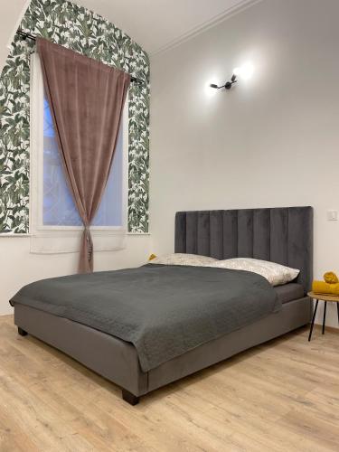 a bedroom with a bed and a window at DMR Apartments in Košice