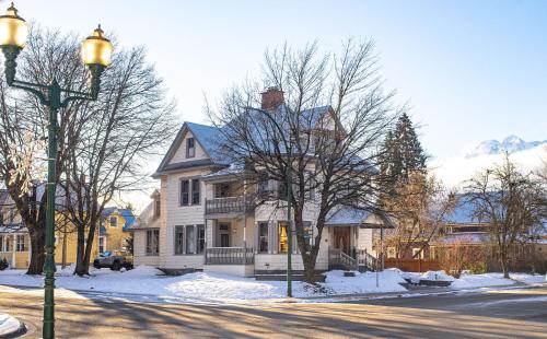 a white house on a street with a street light at The Copeland in Revelstoke