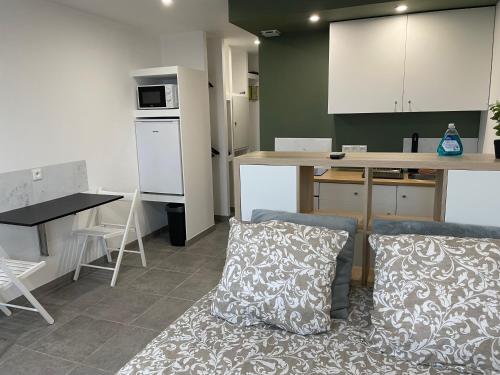 a living room with a couch and a kitchen at Studio vue sur mer classé 3 étoiles, Calais in Calais