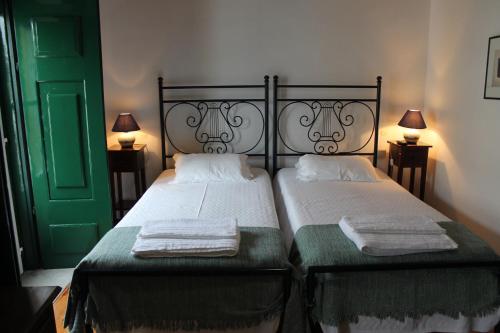 a bedroom with two beds with towels on them at Casa de Viana do Alentejo in Viana do Alentejo