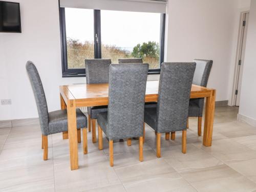 a dining room table and chairs with a window at Rockville in Greencastle