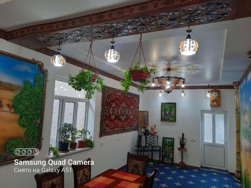 a living room with potted plants on the ceiling at Guest House Khiva BOYJON OTA in Khiva
