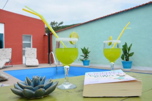 twee glazen sap en een boek op een tafel bij Villa Kata in Sičane