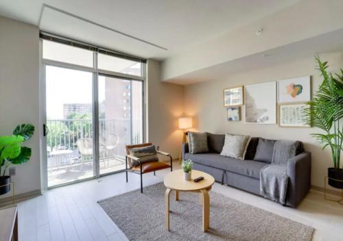 a living room with a couch and a table at Fantastic 2BR Condo With Rooftop in Arlington