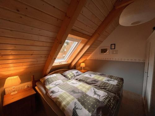 ein Schlafzimmer mit einem Bett im Dachgeschoss in der Unterkunft Hexenstuben Tanne - 4 DTV Sterne in Tanne