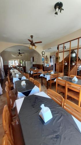 a group of tables and chairs in a restaurant at Hotel Acuarium in Villa Gesell