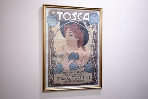 a framed picture of a woman on a wall at Residenza Centro Storico in Lucca