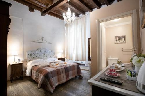 a bedroom with a bed and a desk in it at Residenza Centro Storico in Lucca