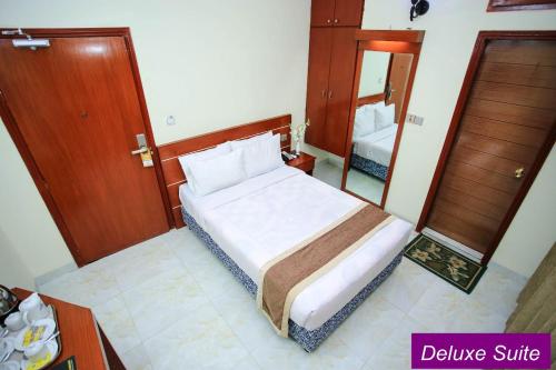a bedroom with a bed and a large mirror at Royal Beach Resort in Cox's Bazar