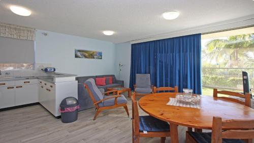 a kitchen and living room with a table and a kitchen and a dining room at Headlands 2 in Port Macquarie