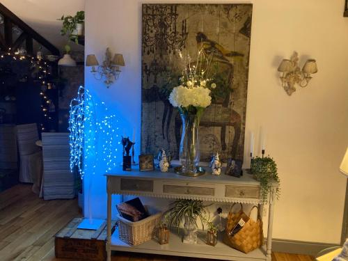 a room with a table with a vase of flowers at Ballybur Lodge Mews 2 in Kilkenny