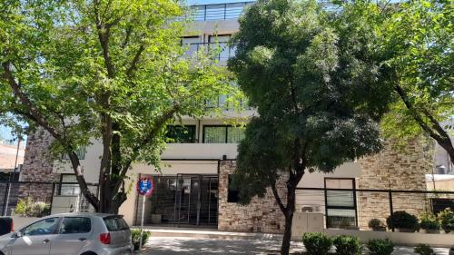 a white car parked in front of a building at Quinta Manuela in Mendoza