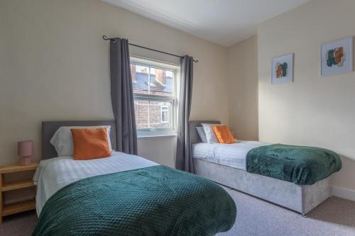 a bedroom with two beds and a window at Milton Stays - Cosy Home in Central York for 6 With On Street Parking in York
