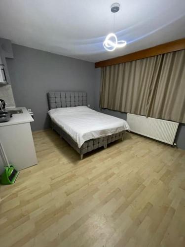 a bedroom with a bed and a wooden floor at Ti6 in Istanbul