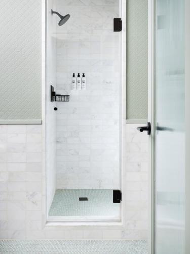 a shower with a glass door in a bathroom at Palihotel Hollywood near Universal Studios in Los Angeles