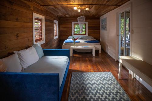 a living room with a couch and a bed at Dolphin Blue Paradise in Bocas del Toro