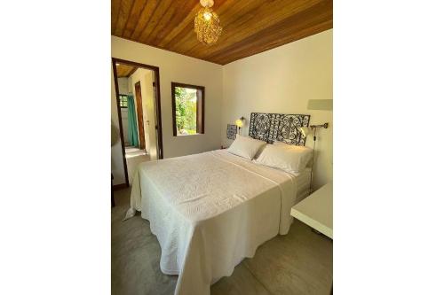 Ένα ή περισσότερα κρεβάτια σε δωμάτιο στο Casa do Mangue-Paraíso na beira do rio Wi-Fi 500M