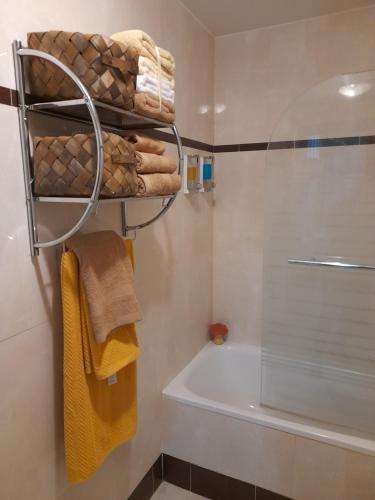 a bathroom with a shower and a tub and towels at El piso de La Zubia "La casa de los poemas" in La Zubia